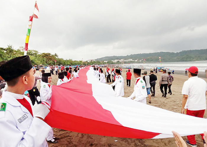 Bangkitkan Rasa Nasionalisme, Bendera Raksasa Dibentangkan di Pantai Pangandaran